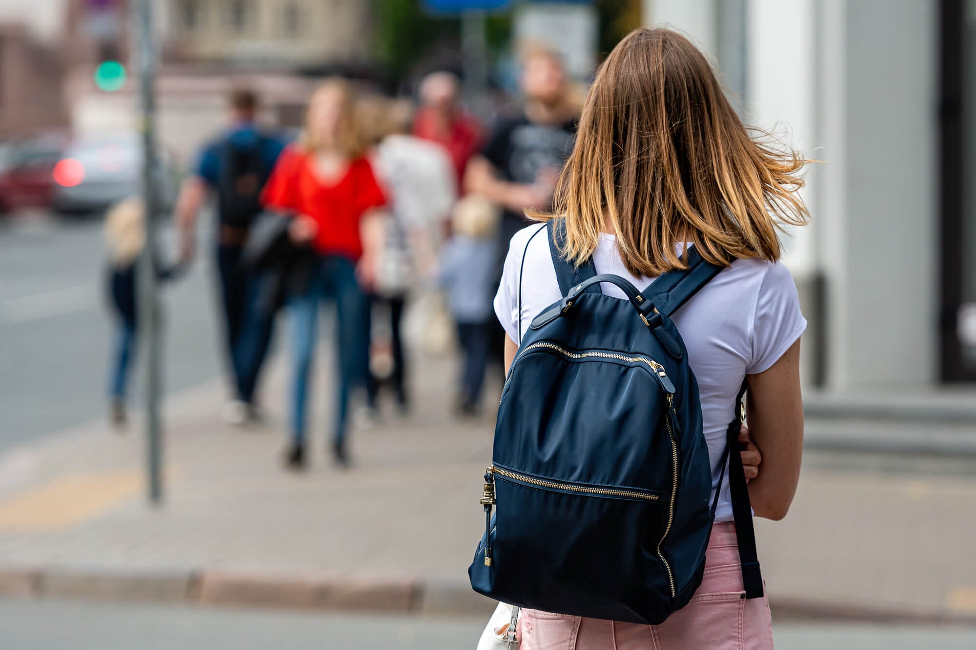 Young teacher heading into class with a light backpack