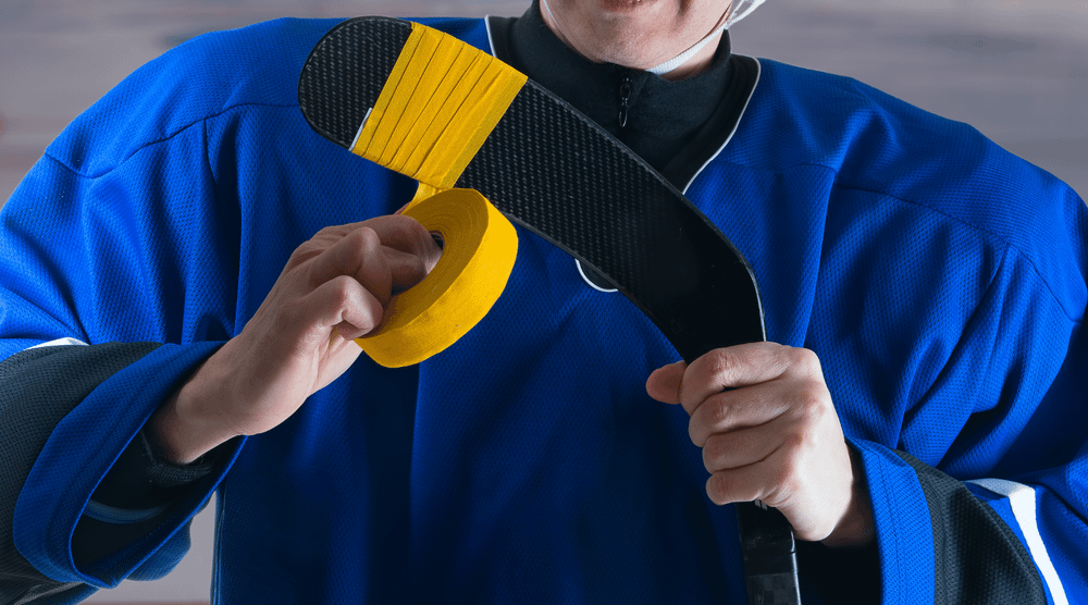 Yellow Hockey Tape being applied to Hockey Stick
