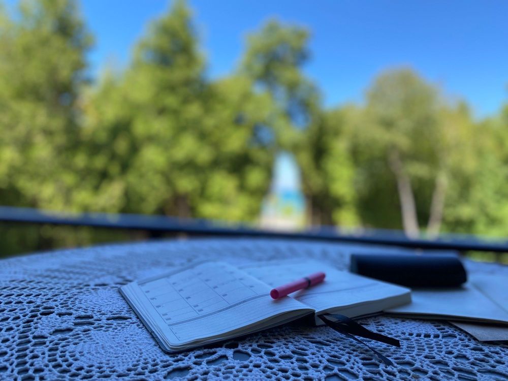 Day Planner at outdoor desk on patio, working from home, lakeside.