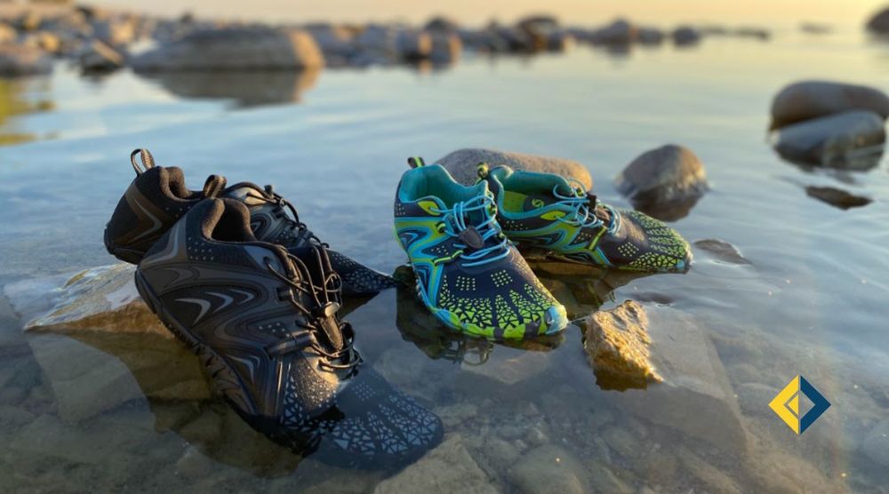 Two pair of water shoes on rocks in the lake.