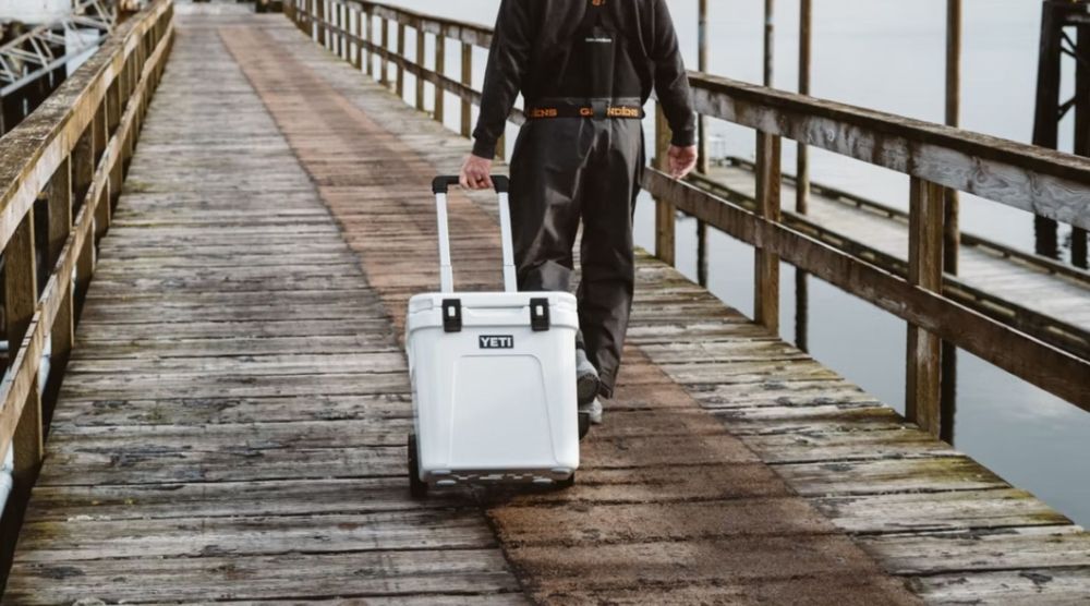 Yeti Hard Cooler on Wheels with man heading out to go fishing | FAV Reviews