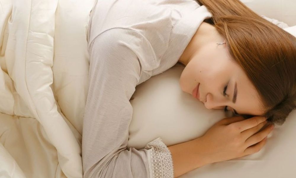 Woman sleeping with Sleep and Beyond Wool Pillows for side sleepers 