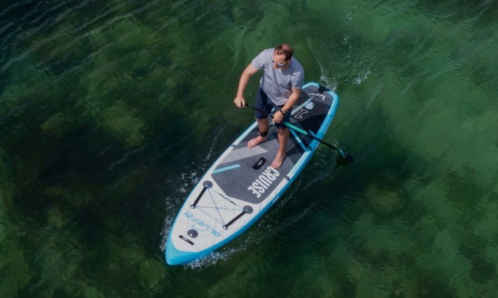 Man Riding BlueFin Cruise Inflatable Stand Up Paddle Board