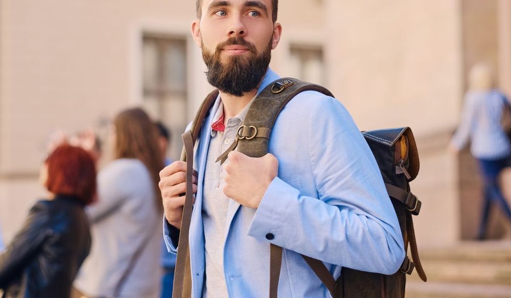 Teacher Backpack - male teacher with backpack outside of school