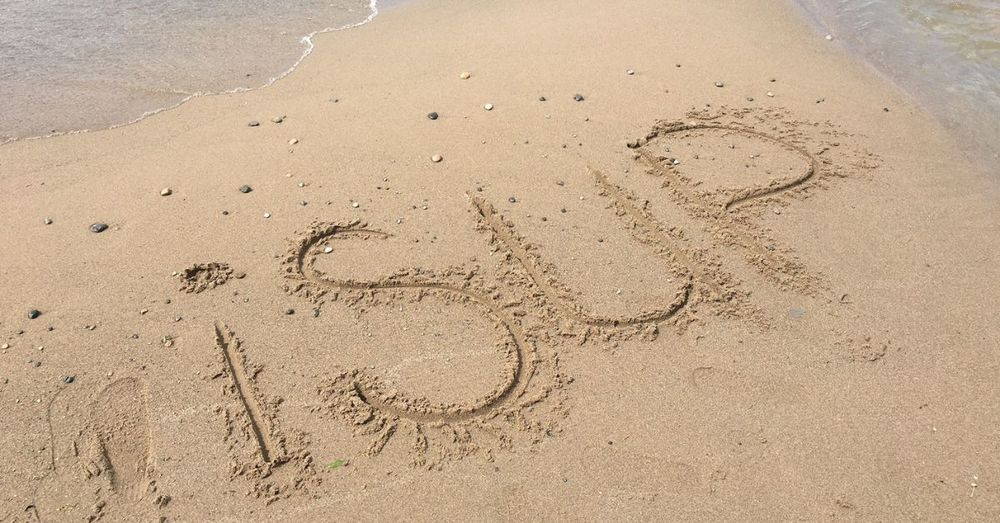 iSUP written in the sand at the beach