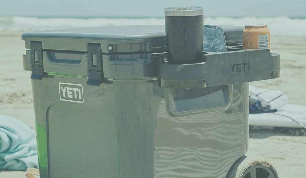 Yeti Hard Cooler with Wheels at the Beach with side accessory for drinks | FavReviews.com