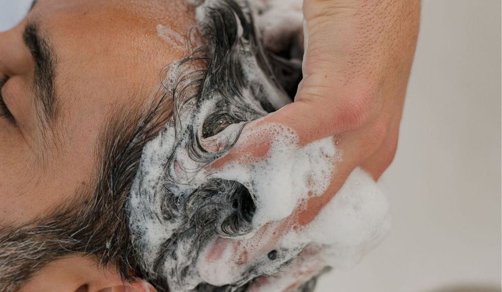 A gentleman getting a hair shampoo