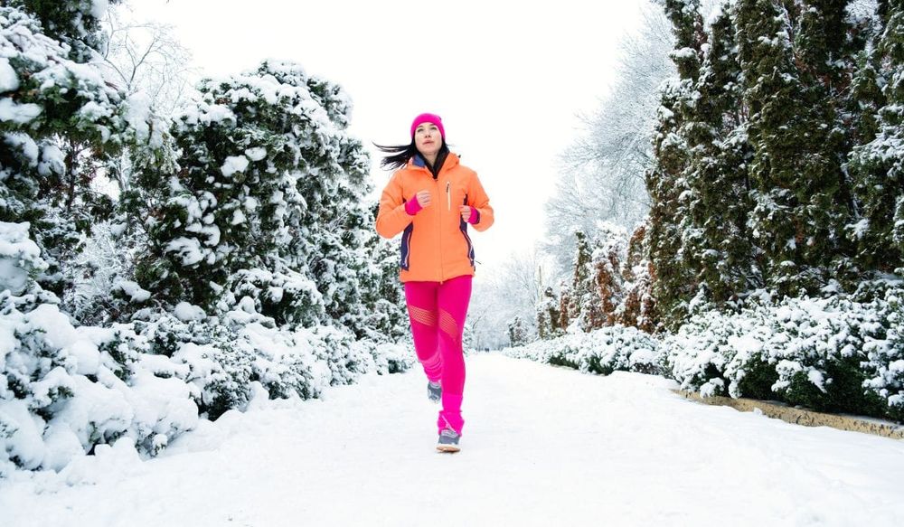 Woman on a winter run wearing a Smartwool base layer for added warmth