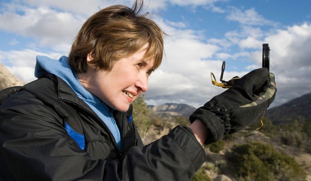 Woman using a compass - navigate your next adventure with precision - best compass