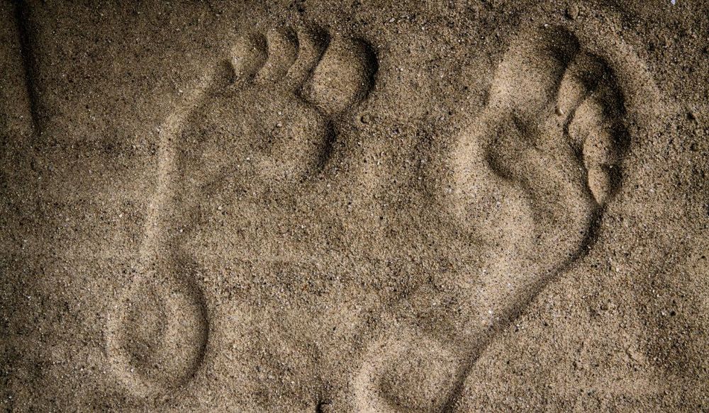 Barefoot art: a foot mould in the sand