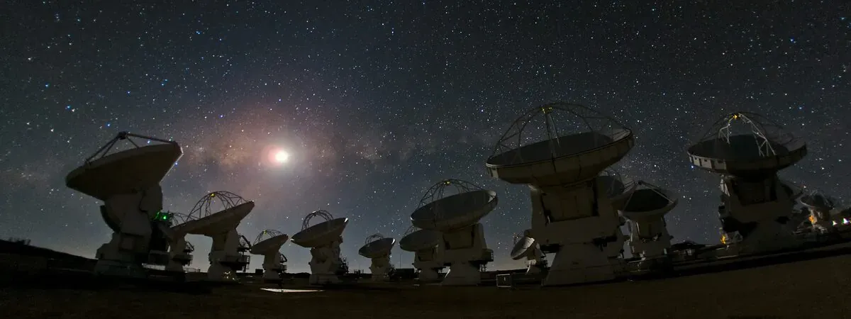 The ALMA array of radio antennas under a starry sky in Chile's Atacama Desert