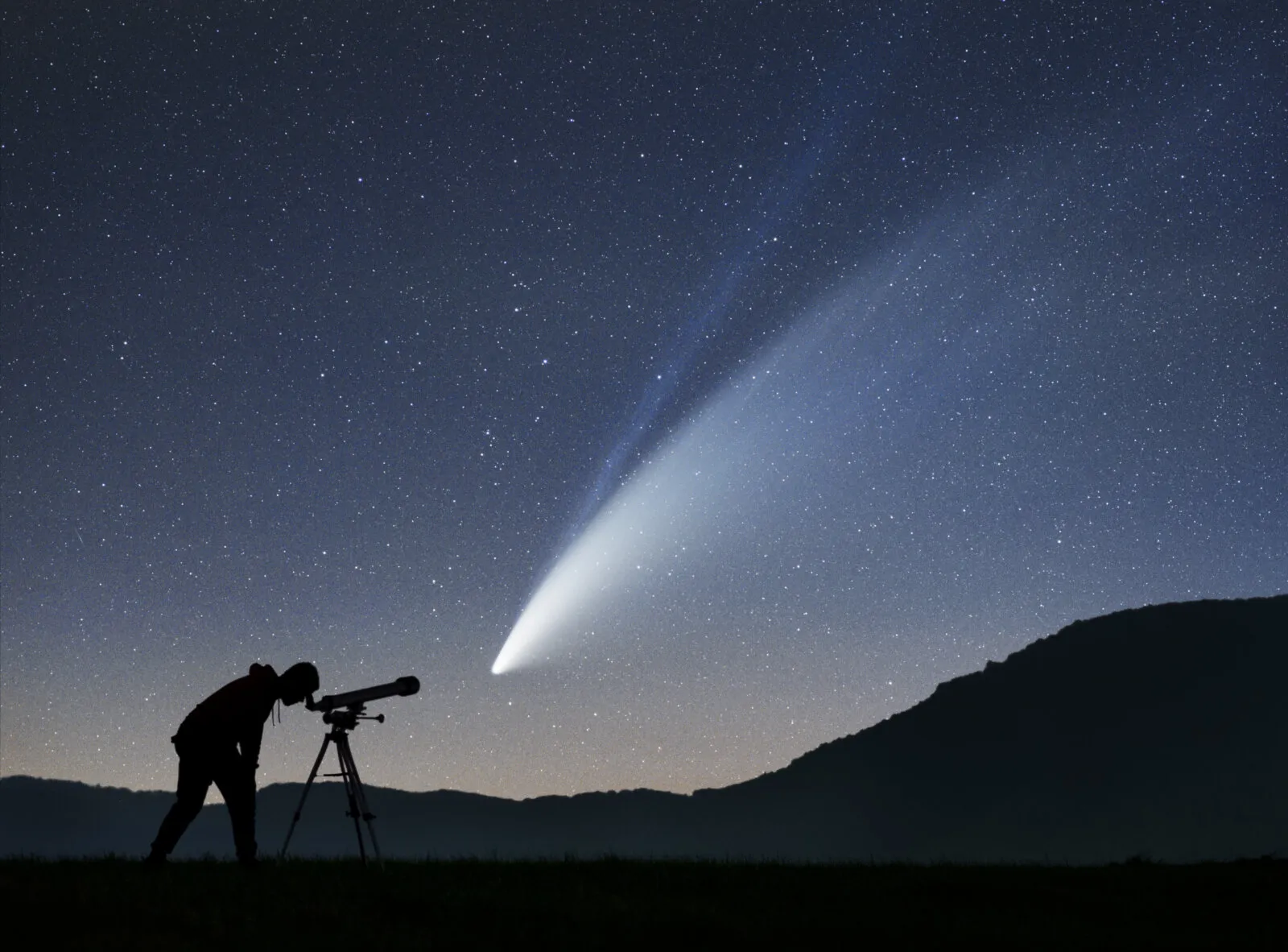 Comet NEOWISE (C/2020 F3) with its dust and ion tails in the night sky in July 2020