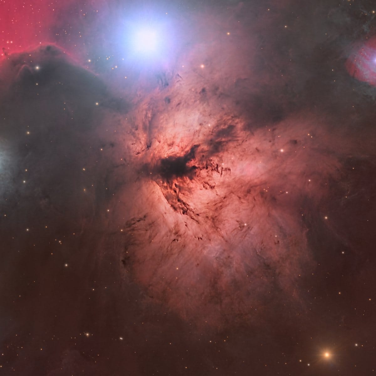 The Flame Nebula (NGC 2024), a glowing emission nebula near Alnitak crossed by a dark central dust lane, close to the Horsehead Nebula