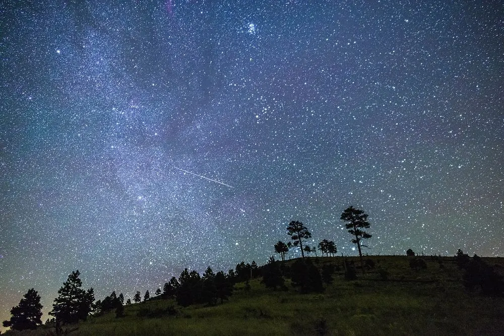 A bright Perseid meteor over the night sky