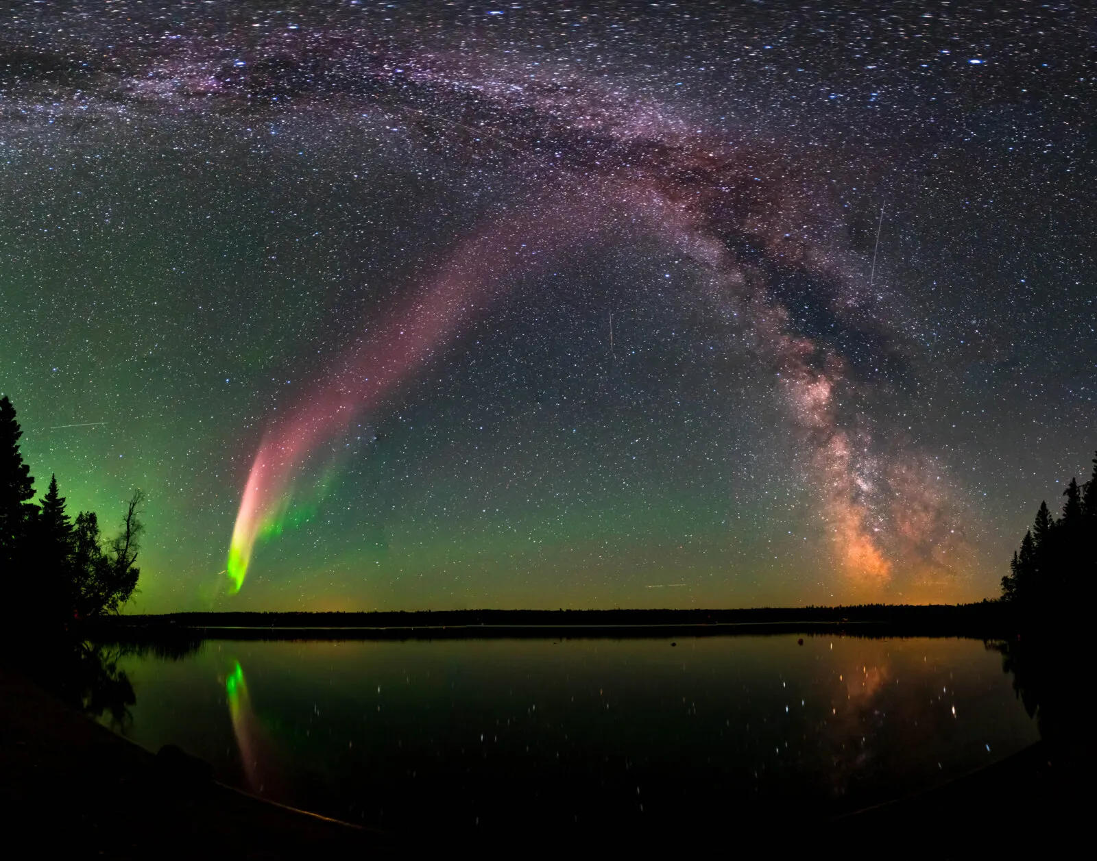 STEVE, a mauve ribbon of light in the night sky alongside the green aurora
