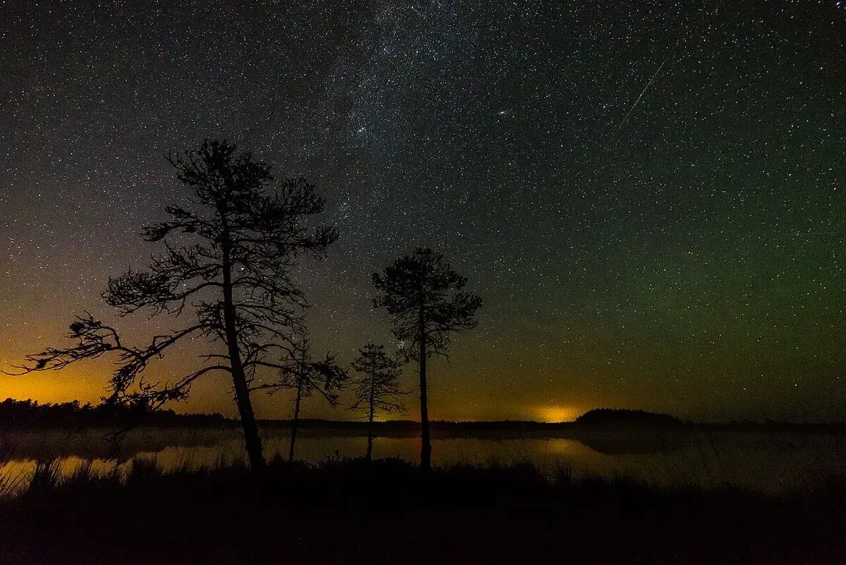 A Perseid meteor streaking over the Milky Way during a meteor shower