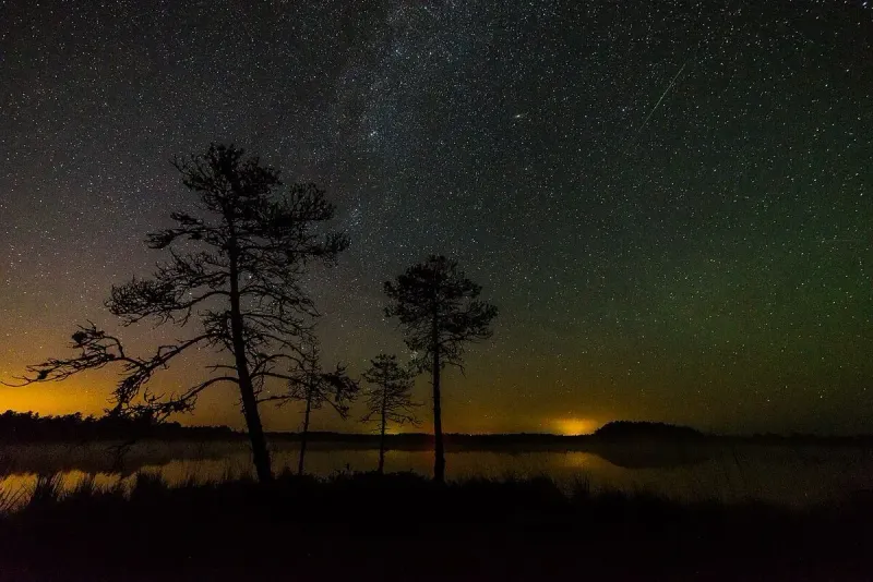A Perseid meteor streaking over the Milky Way during a meteor shower