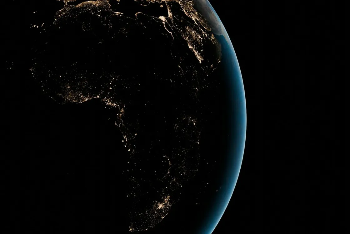 Africa and the Middle East at night from space, with city lights highlighting hubs across North, West, East, and Southern Africa and the Gulf.