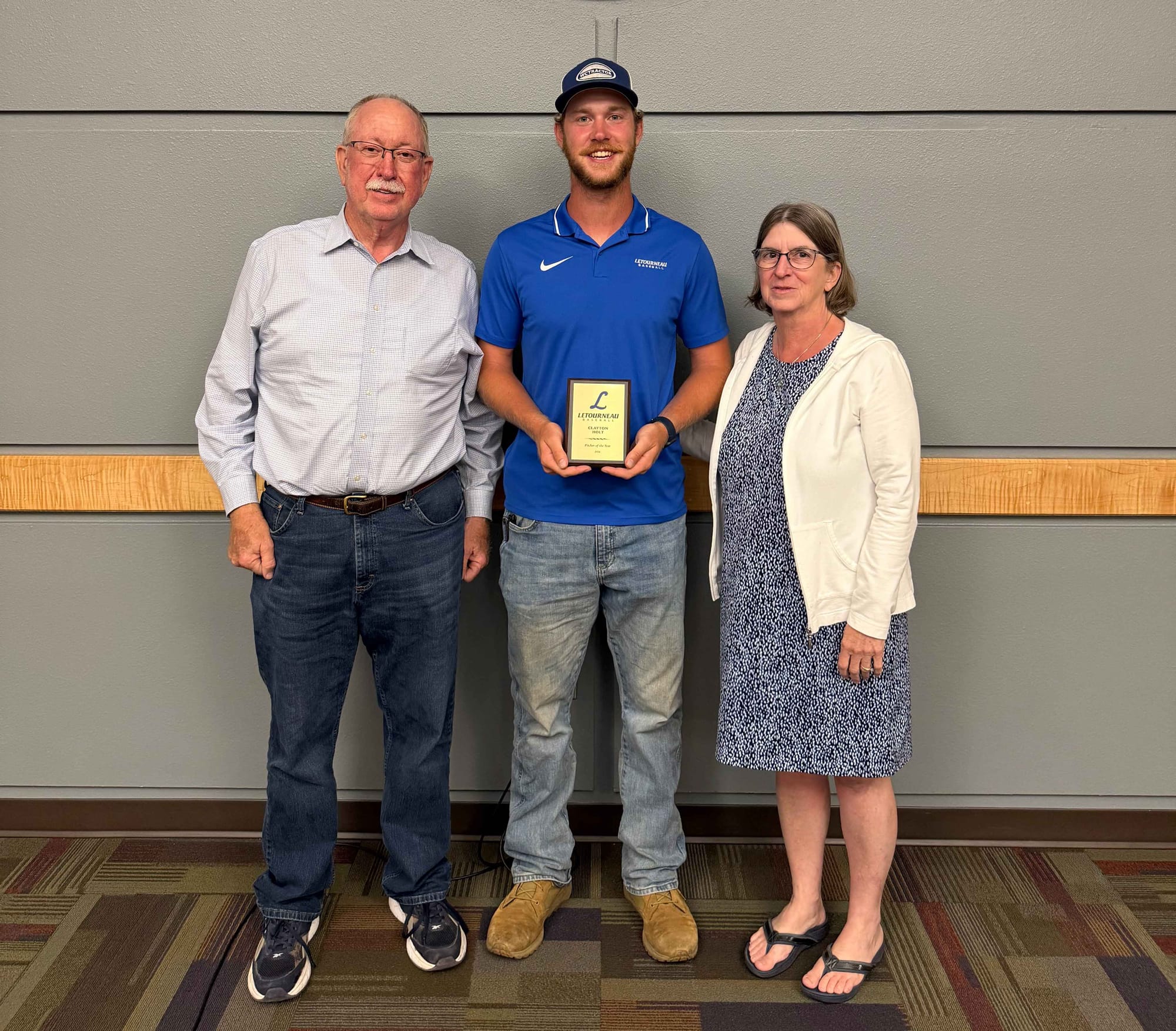 Clayton Holt poses with his parents Tom and Barbara Holt after the LeTourneau baseball awards dinner.