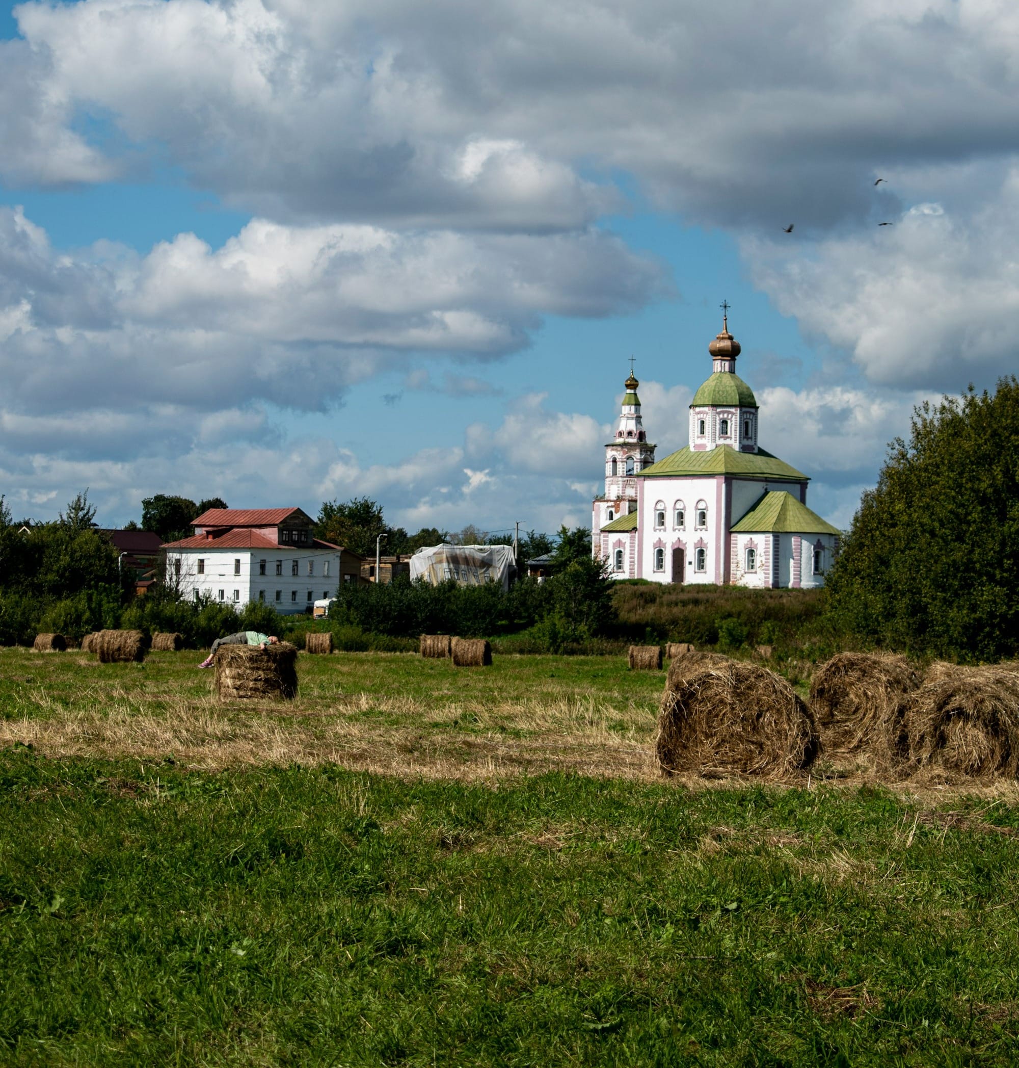a large white church with a green roof