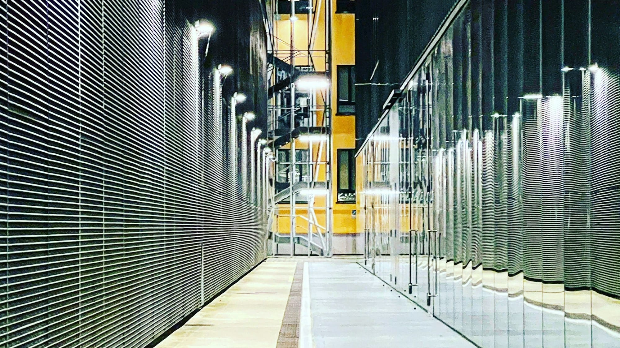 a long hallway with a clock on the side of it