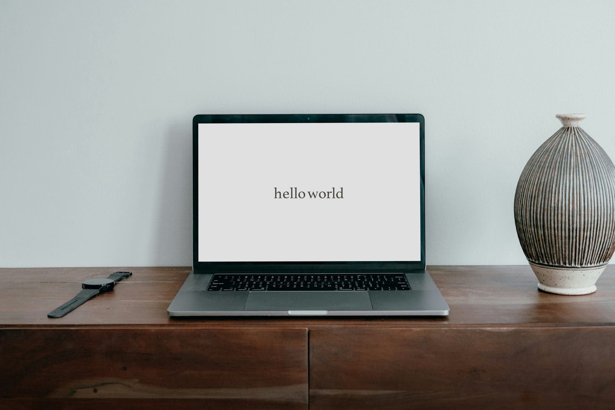 Laptop computer with the words "hello world" on display
