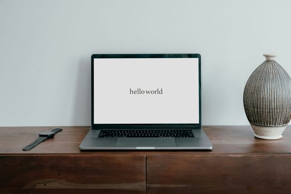 Laptop computer with the words "hello world" on display