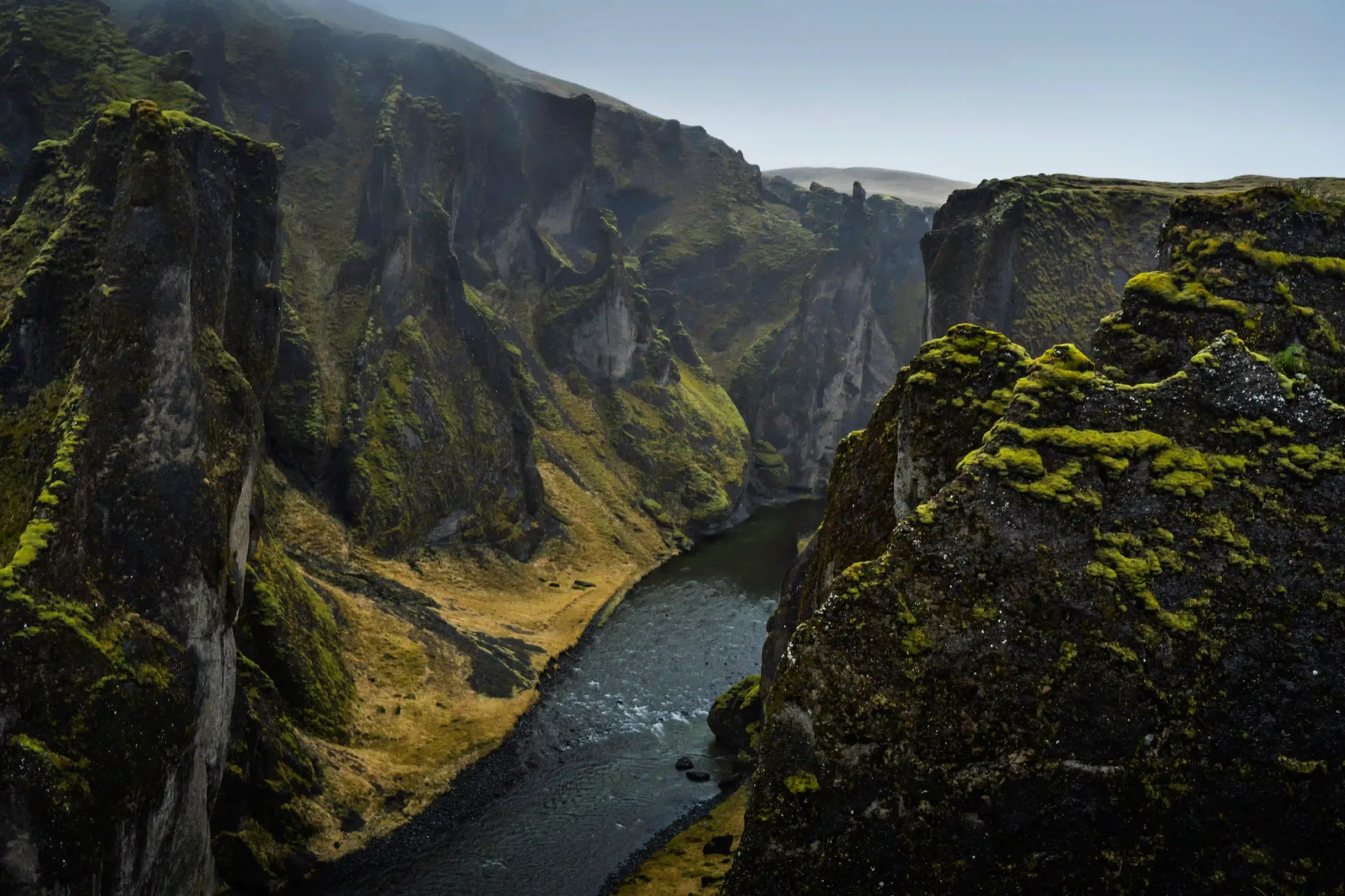 A dramatic view of the fragile, moss-covered Fjaðrárgljúfur canyon in Iceland, which was heavily impacted by mass viral tourism.