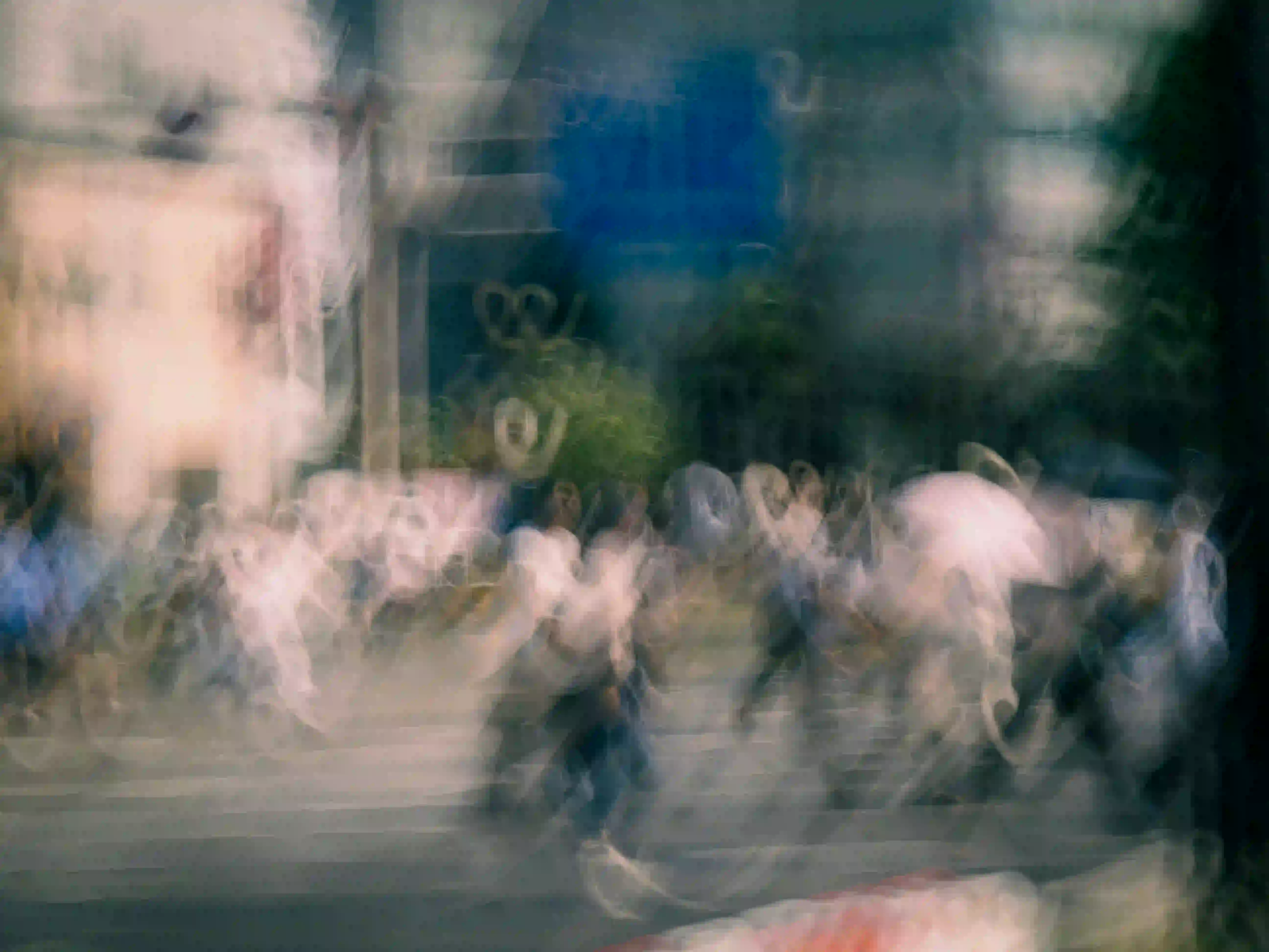 A highly abstract, motion-blurred photograph of a rushing city crowd, rendering the pedestrians as faceless, ghost-like silhouettes in constant movement.