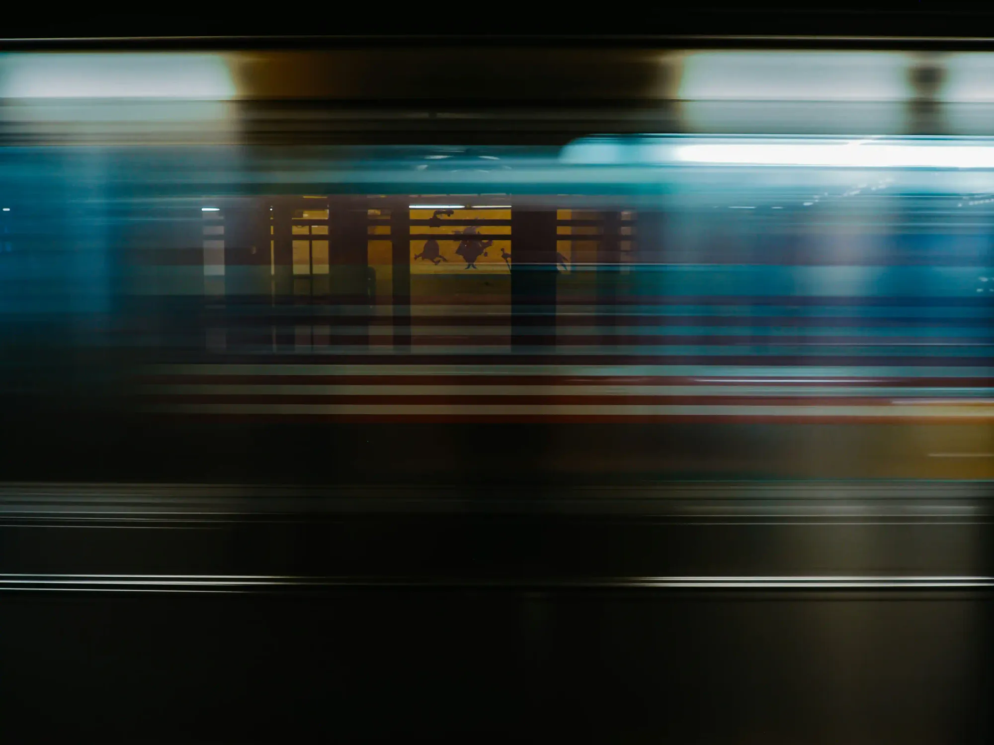 Long-exposure shot of a moving train creating abstract motion lines resembling an urban transit network.