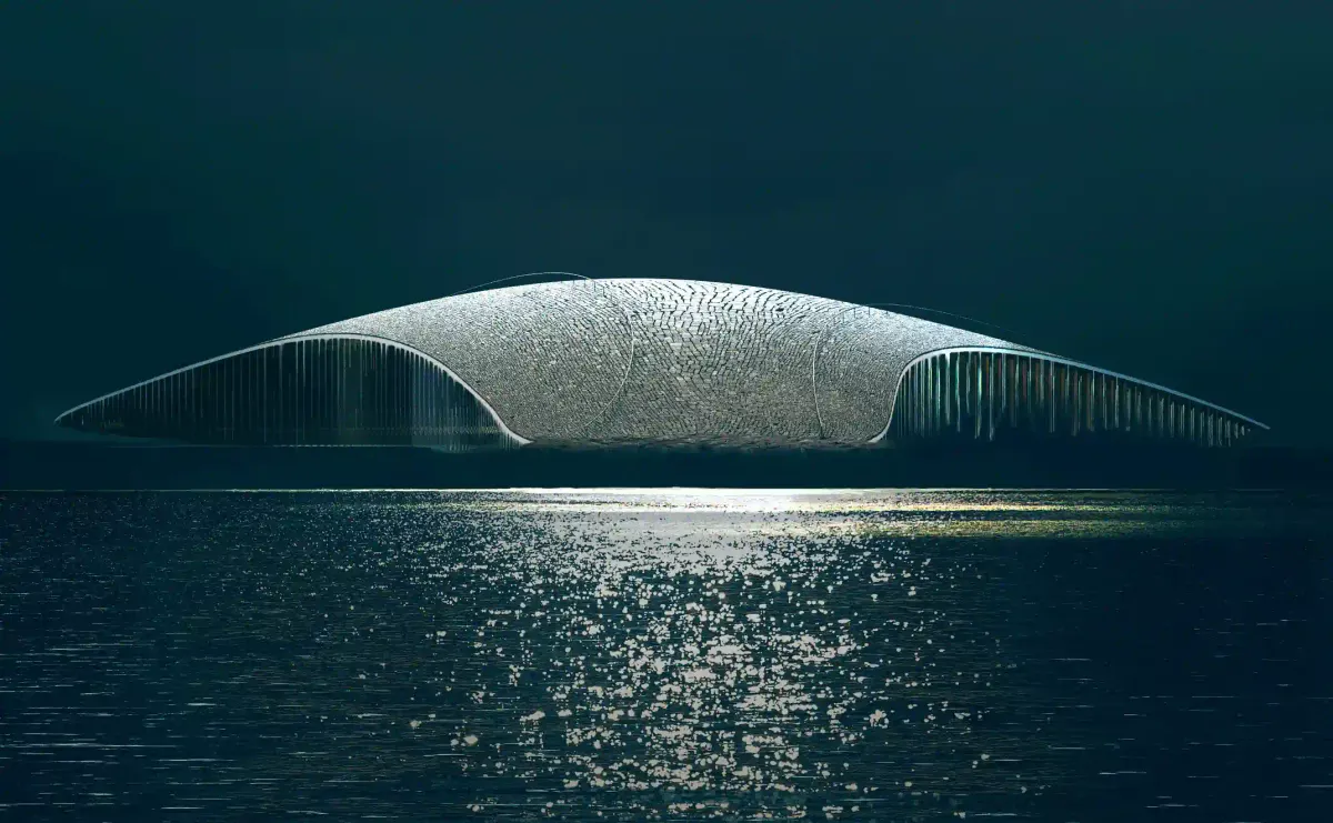 A striking night rendering of The Whale museum in Norway, glowing softly in the dark Arctic waters like a bioluminescent deep-sea creature.