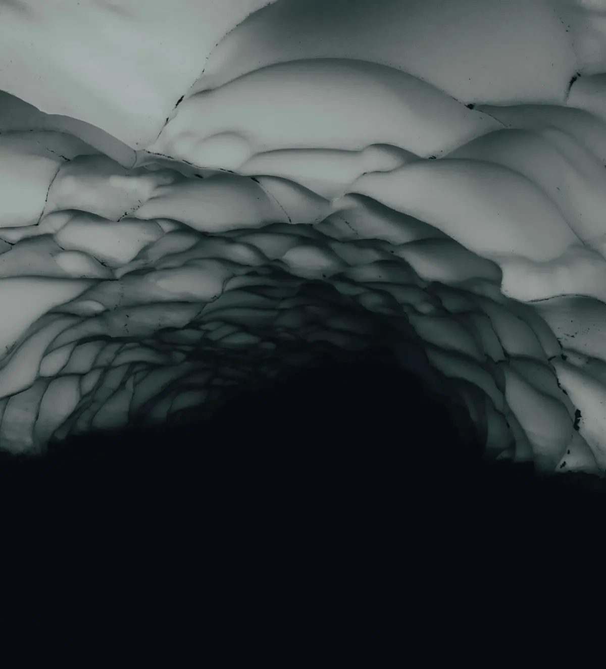 A dark, abstract view looking up from within a cave towards a textured, icy ceiling, representing architectural surrender.