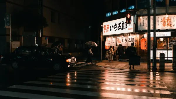 A cinematic rainy night in Tokyo, featuring a black taxi and a bright storefront, illustrating the aestheticization of everyday urban Japan.