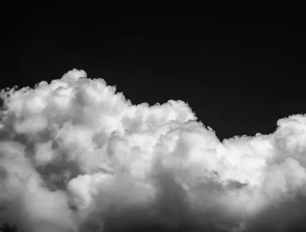 A stark, heavy cloudscape dividing a dark sky, representing the environmental crisis and property debates surrounding cloud seeding.