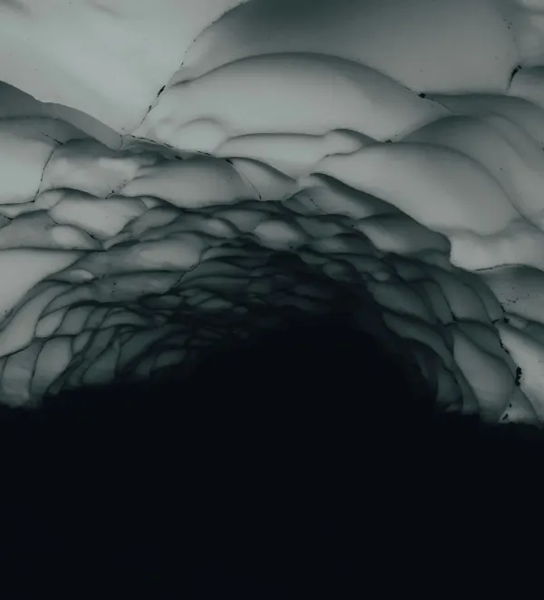 A dark, abstract view looking up from within a cave towards a textured, icy ceiling, representing architectural surrender.