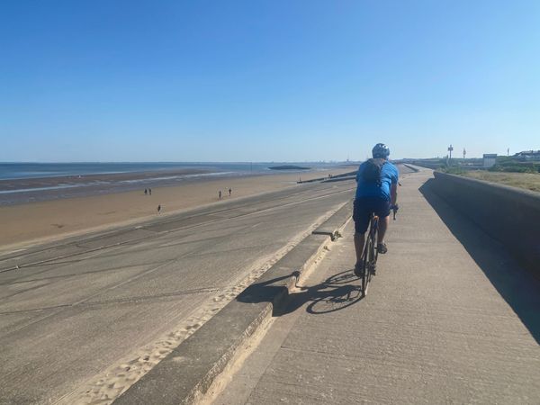 Cycling along the coastal defences towards New Brighton.