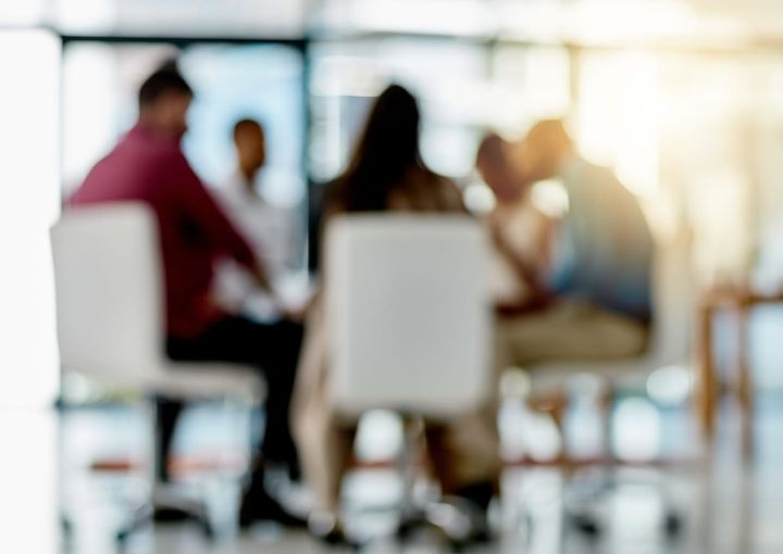 blurred image of leaders sitting at a table together