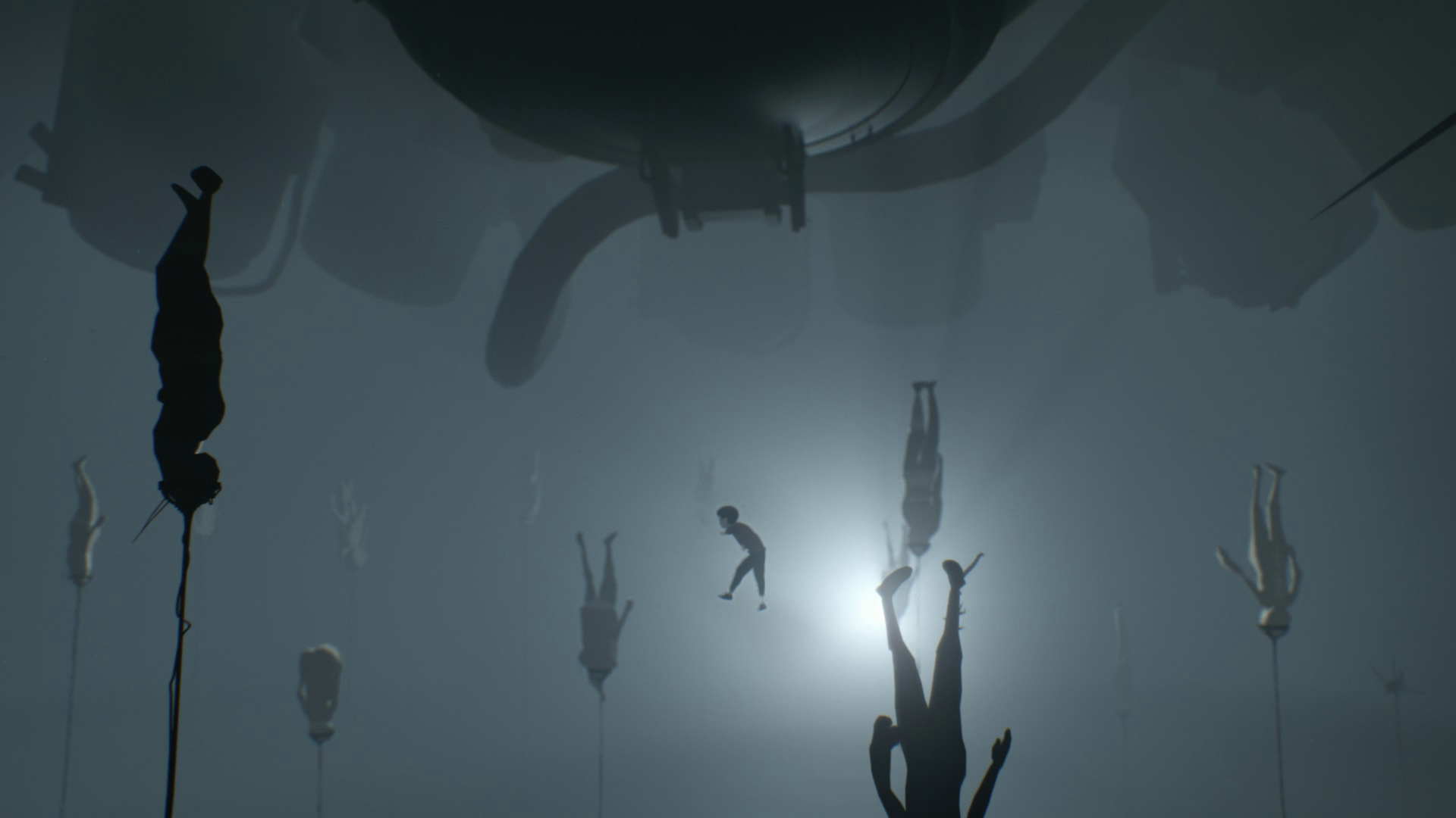 INSIDE: a boy's silhouette drifts through murky water among rows of limp human figures suspended on poles, backlit by a single pale glow.