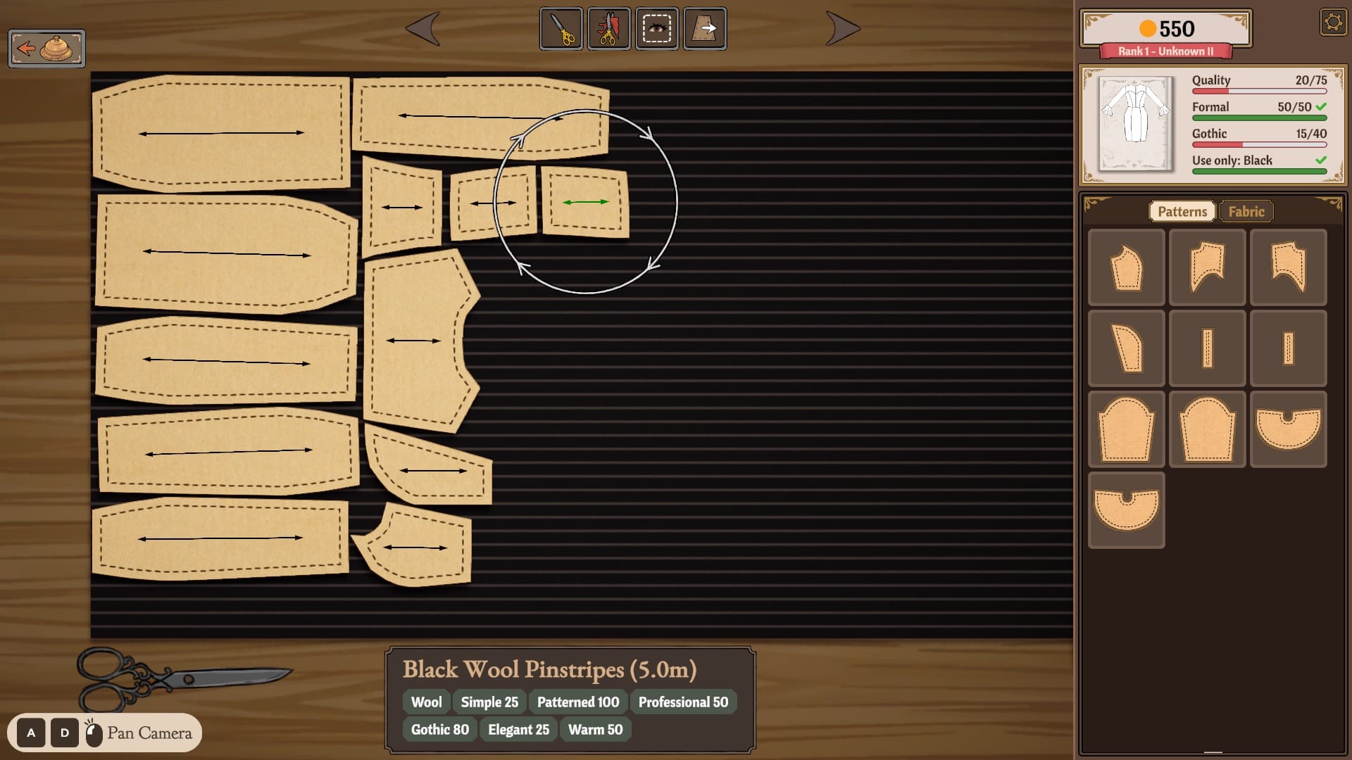 The cutting table in Dressmaker. The player aligns pattern pieces on black wool pinstripe fabric.
