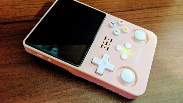 A Gamelab R36S console in pink with white buttons.