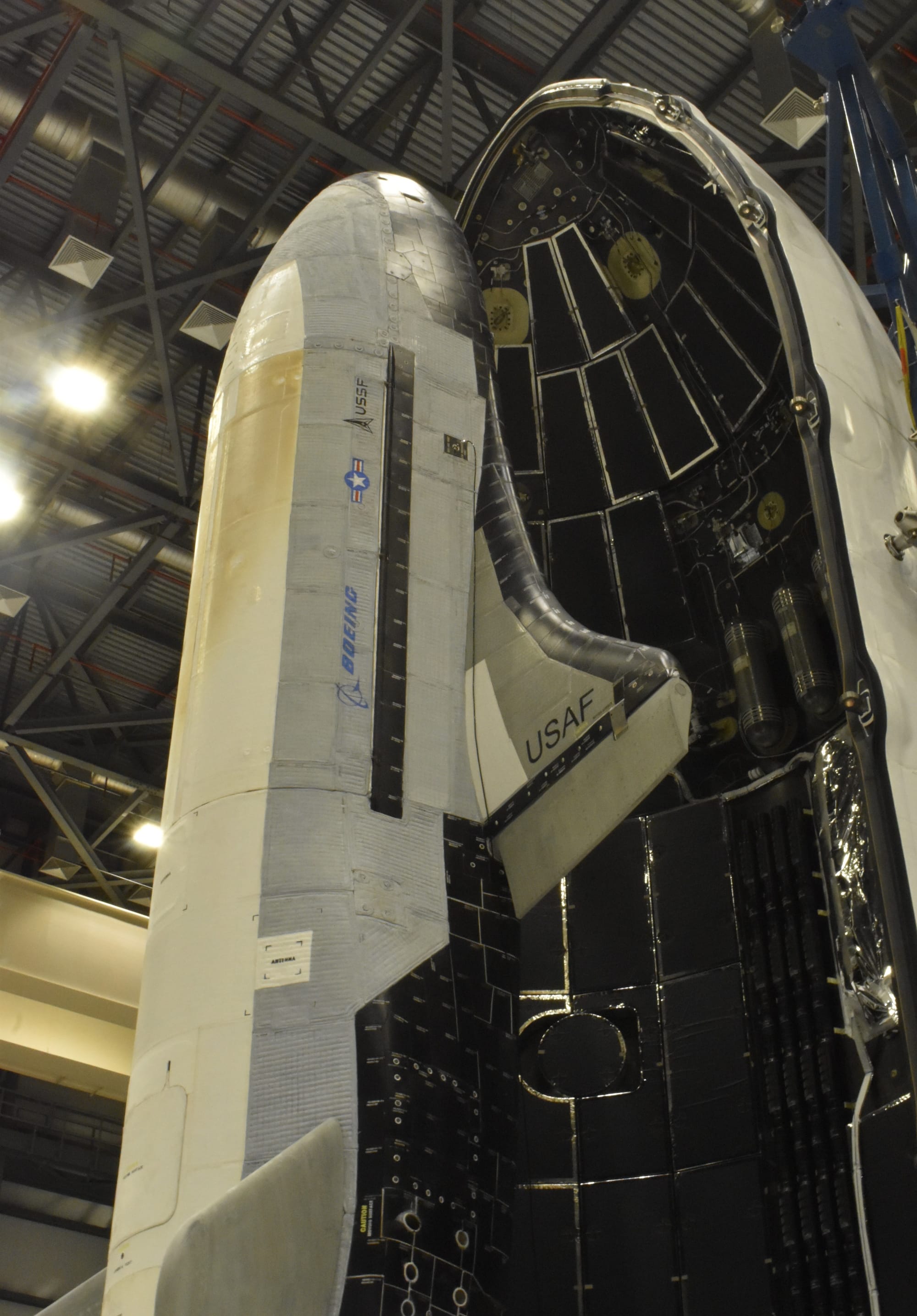 Boeing's X-37B Vehicle 2 as it undergoes encapsulation within Falcon Heavy's fairings in its payload processing facility. ©USSF/Boeing