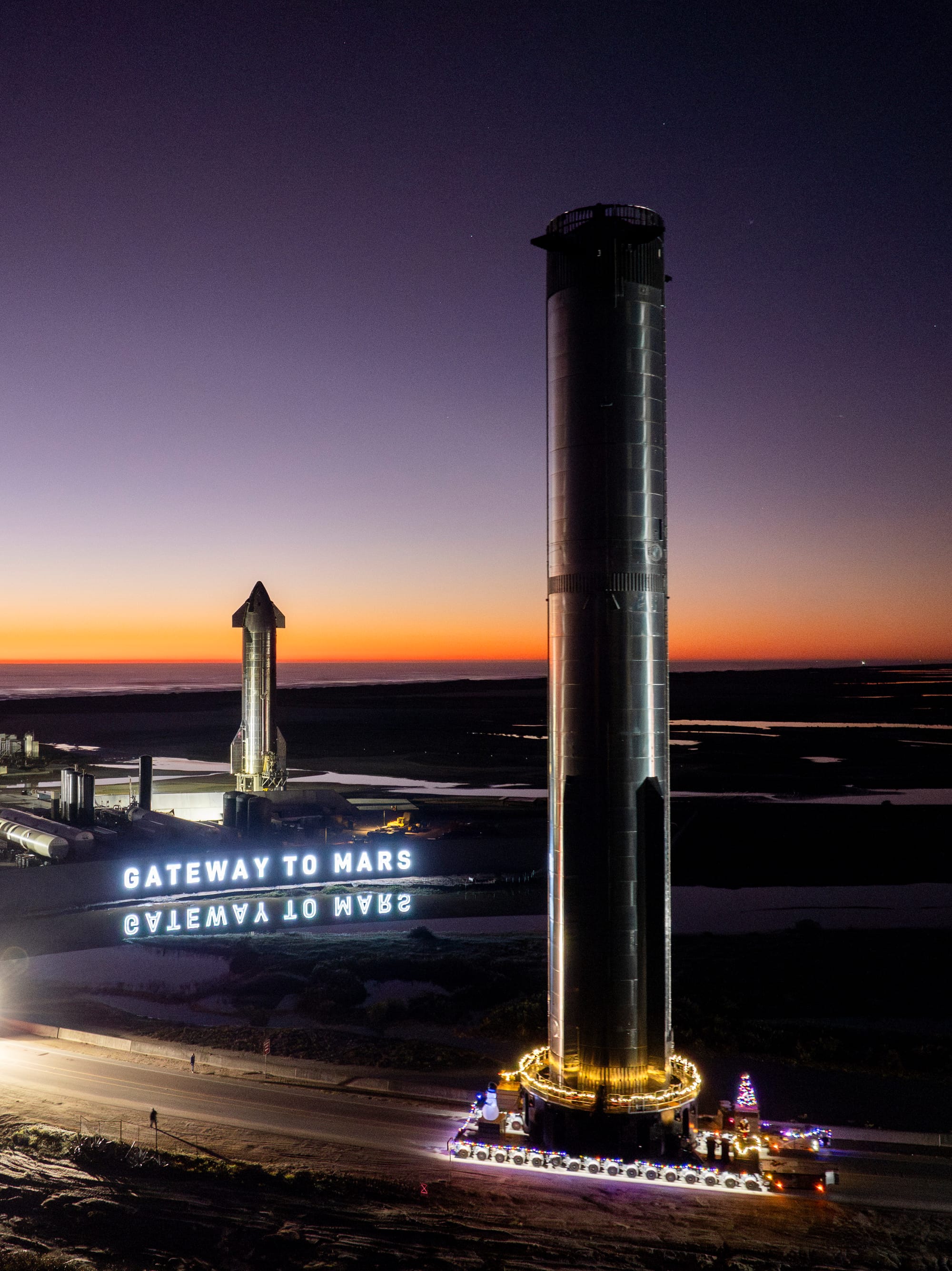 Super Heavy Booster 10 during rollout passing by Ship 28 in the background. ©SpaceX