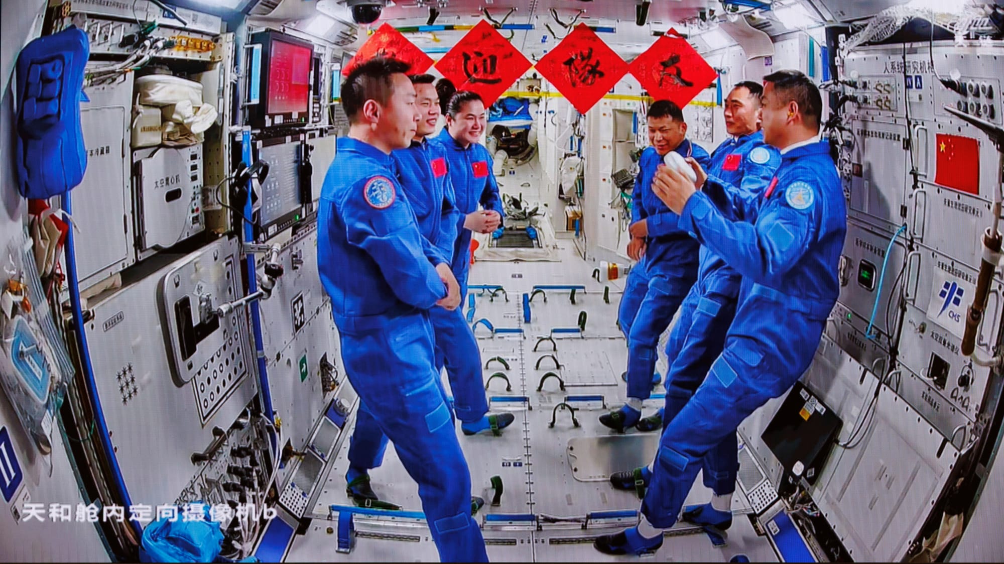 The Shenzhou-19 crew, Cai Xuzhe, Song Lingdong, and Wang Haoze, (left) speaking with the new Shenzhou-20 crew, Wang Jie, Chen Zhongrui, and Chen Dong, (right). ©China Manned Space Agency