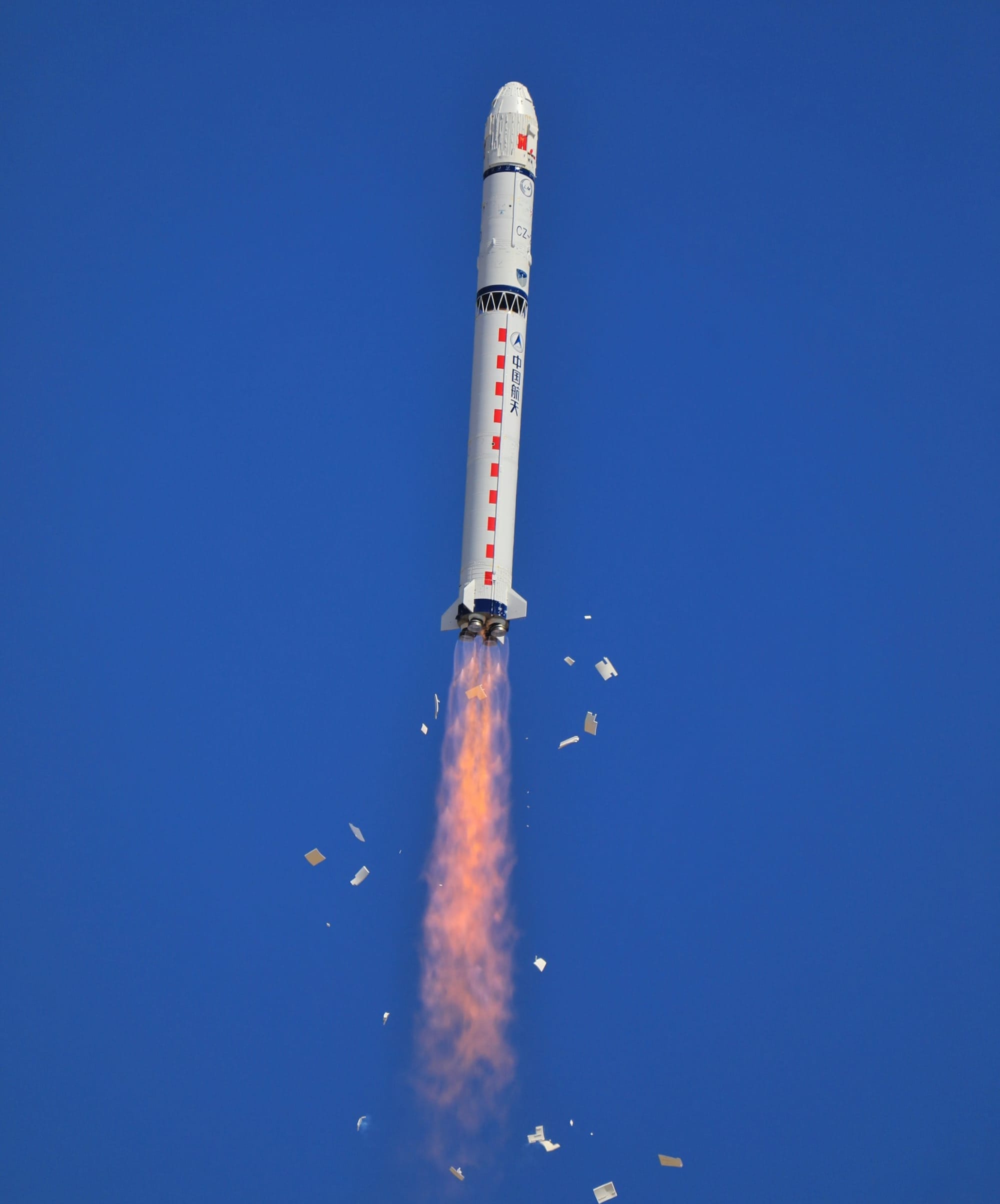 The Long March 2D Y42 vehicle during first-stage flight, with pre-launch thermal protection covers falling away.