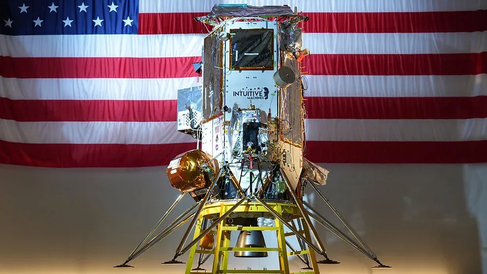 Intuitive Machines lunar lander Odysseus (IM-1) spacecraft displayed in front of the American flag before its Moon mission, part of NASA’s Commercial Lunar Payload Services program.