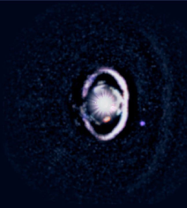 Young star WISPIT 2 with forming exoplanet WISPIT 2b captured in telescope image, showing dusty rings of gas where a massive Jupiter-like proto-planet is accreting material, located 437 light years away.