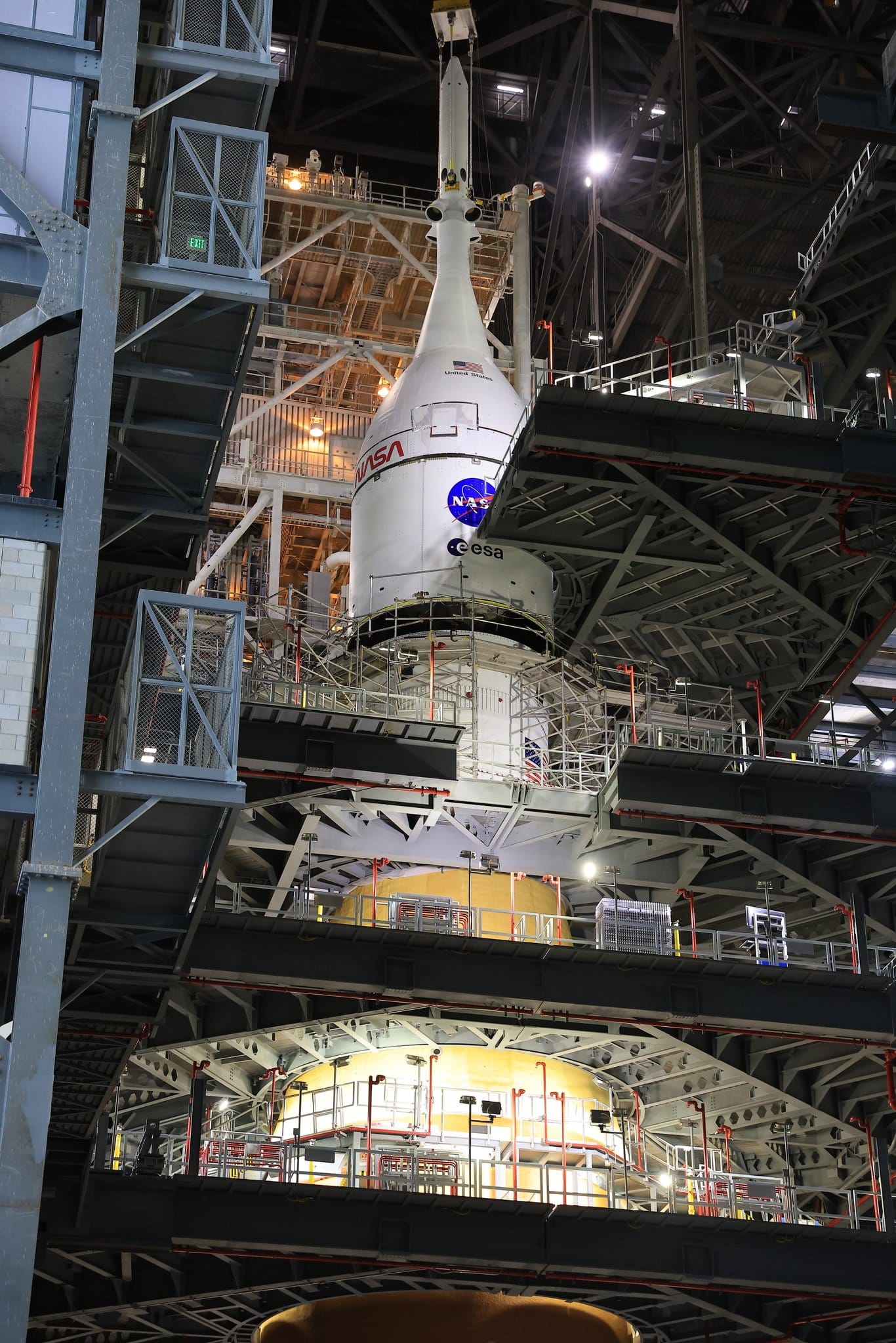 Artemis II's Orion spacecraft being placed atop of Space Launch System in the Vehicle Assembly Building. ©NASA
