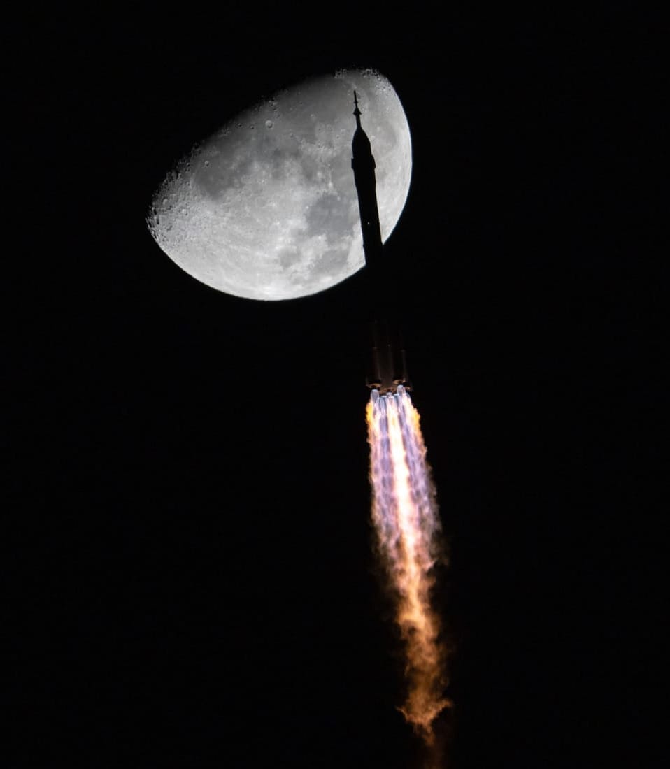 The Long March 2F/G Y21 vehicle during first-stage flight while passing in front of the Moon for the launch of the Shenzhou-21 mission.