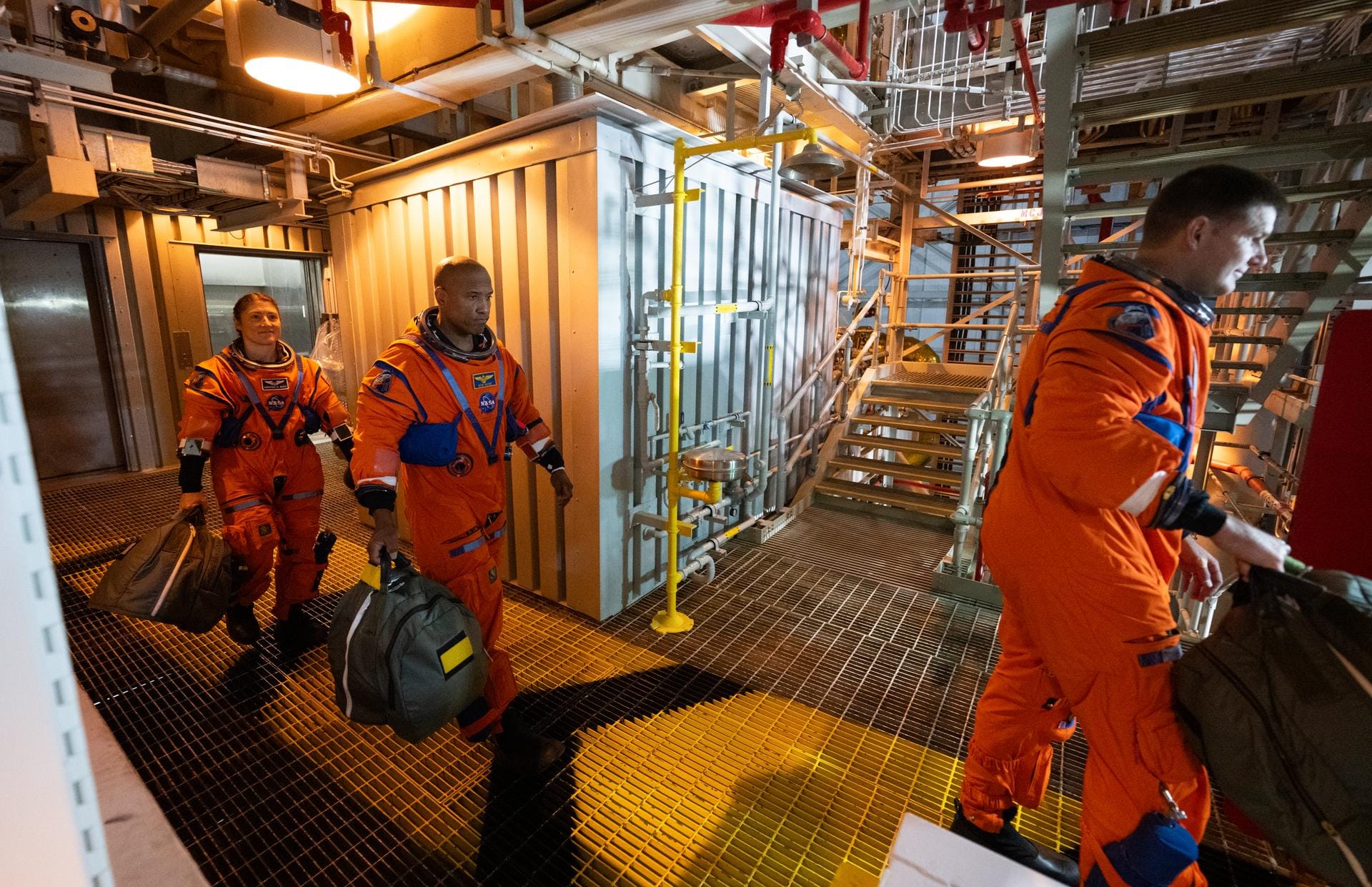 Artemis II astronauts Christina Koch (left), Victor Gover (center), and Jeremy Hansen (right) walking through the Mobile Launch Platform towards their Orion spacecraft. ยฉJoel Kowsky/NASA