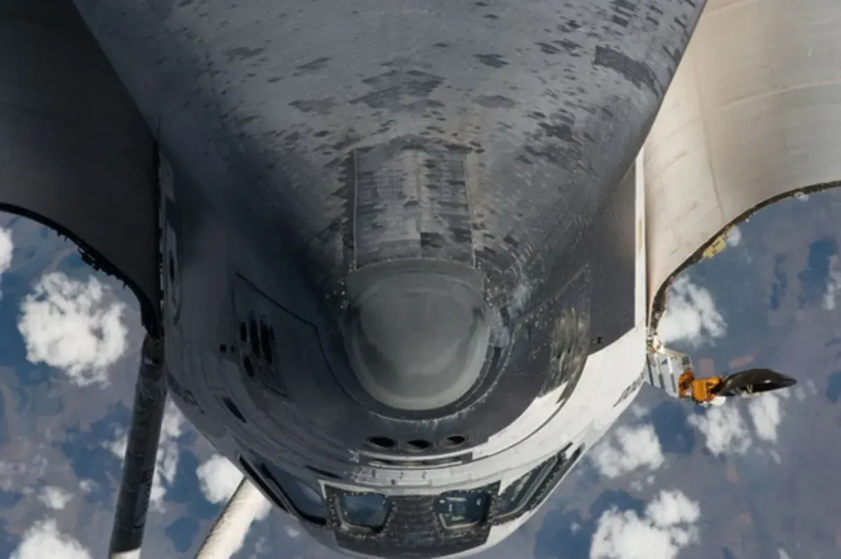 NASA's space Shuttle Endeavour's heat shield being inspected by the crew aboard the ISS